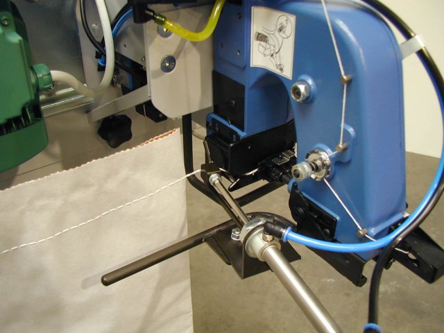 bag closing machine sewing a bag